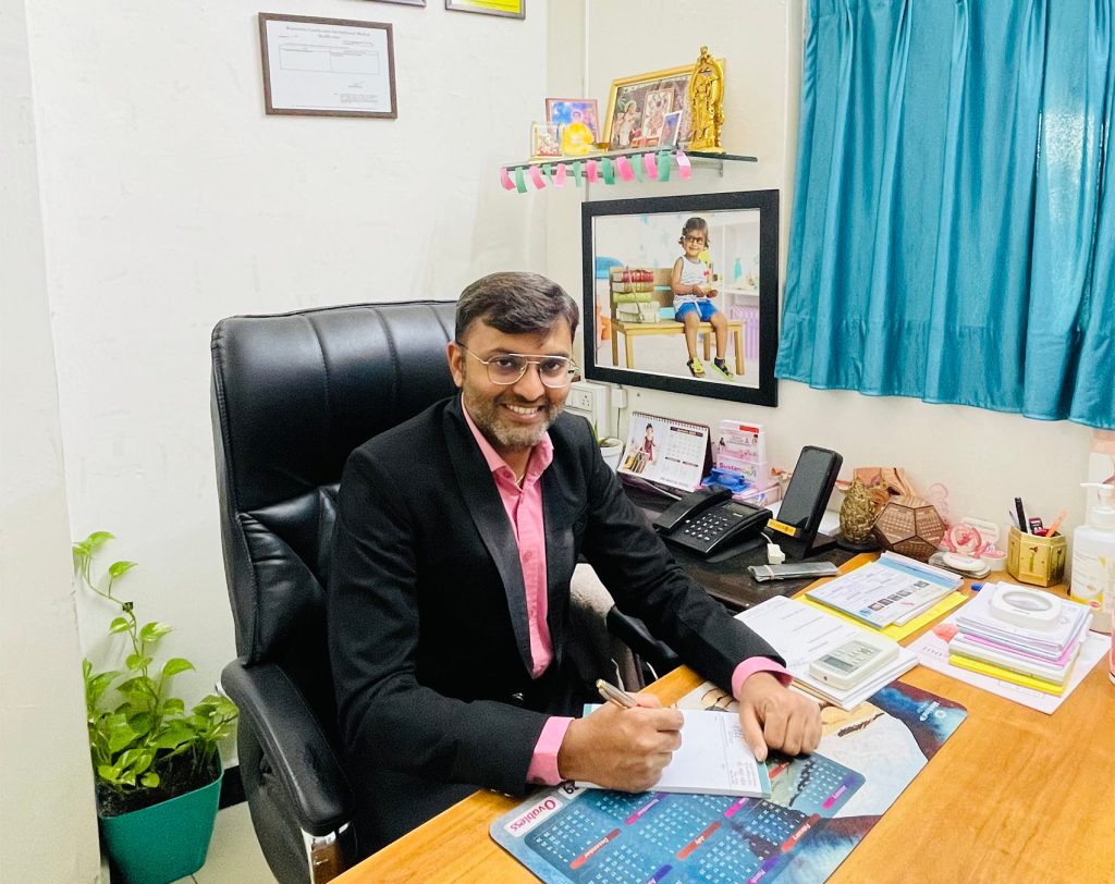 Dr Mayur seating on his table